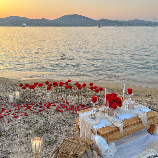 Romantic scenography (large roses stuck in the sand, LED candles)